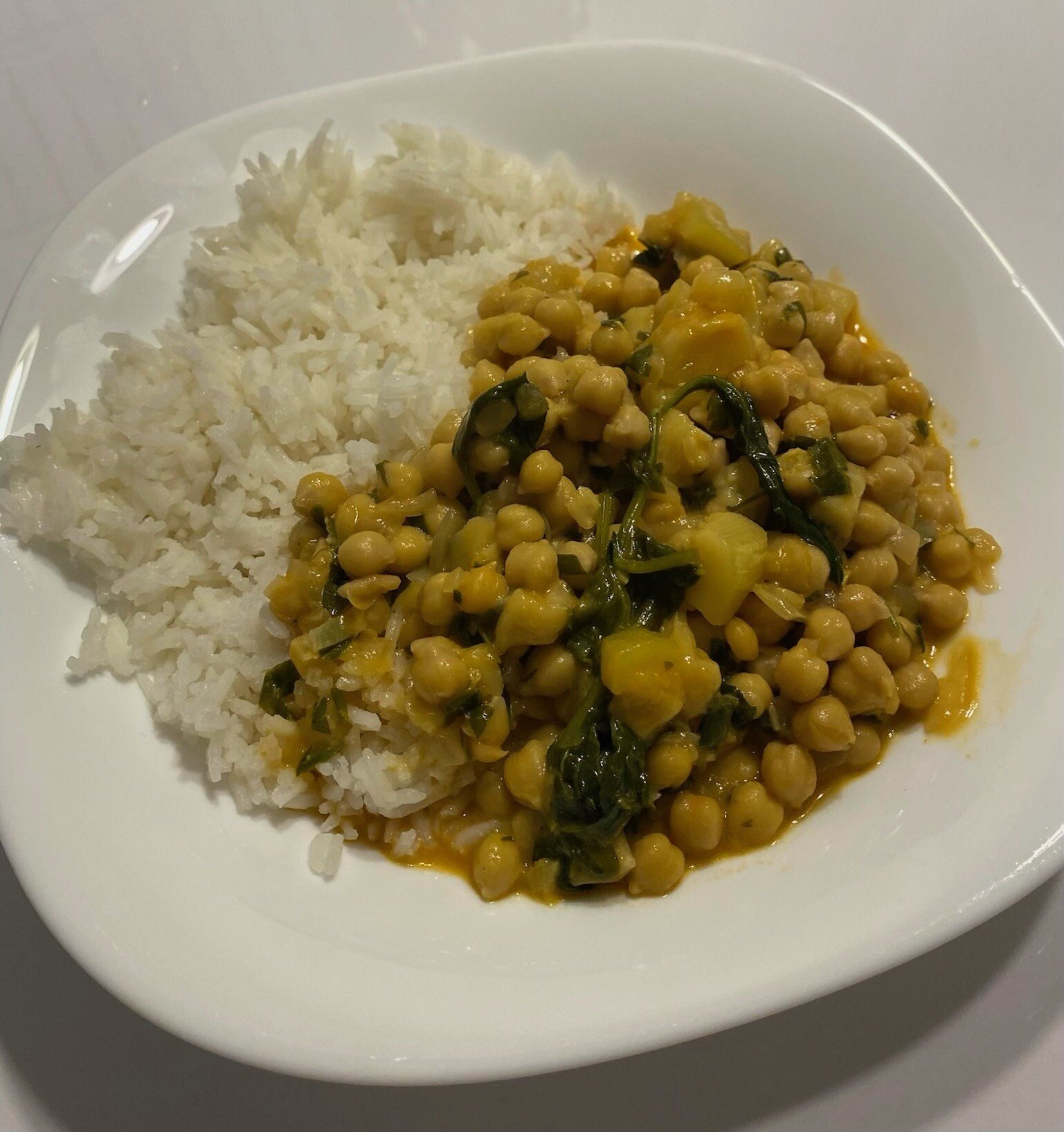 Chickpea curry served with white rice on a plate