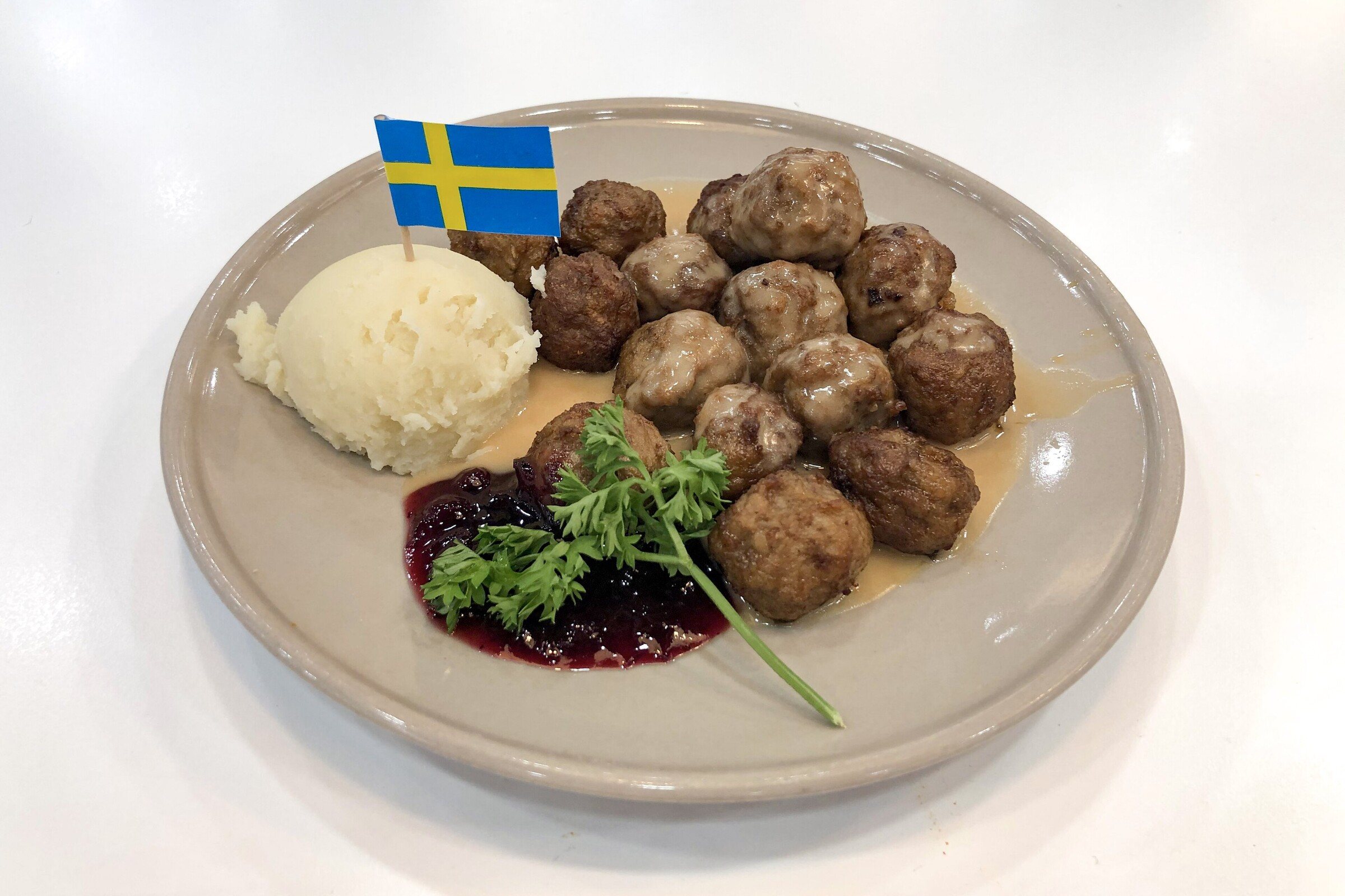 Swedish meatballs with mashed potatoes and lingonberry jam on a plate